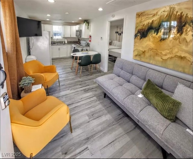 621 S 9th St, Las Vegas, NV 89101 - living room featuring light wood finished floors and recessed lighting