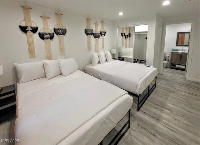 621 S 9th St, Las Vegas, NV 89101 - bedroom with light wood-type flooring, recessed lighting, and connected bathroom