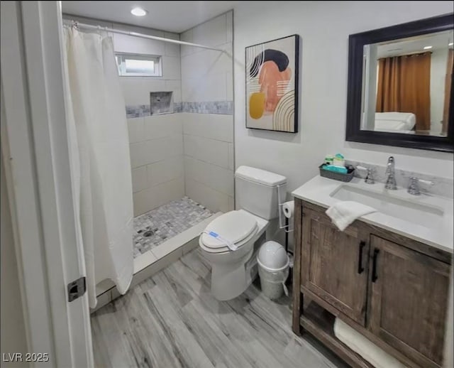 621 S 9th St, Las Vegas, NV 89101 - bathroom featuring vanity, tiled shower, and wood finished floors