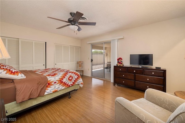 4219 E Pinecrest Cir, Las Vegas, NV 89121 - bedroom with access to outside, wood finished floors, two closets, a textured ceiling, and a ceiling fan