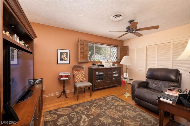 4219 E Pinecrest Cir, Las Vegas, NV 89121 - living area featuring a ceiling fan, a textured ceiling, wood finished floors, and baseboards