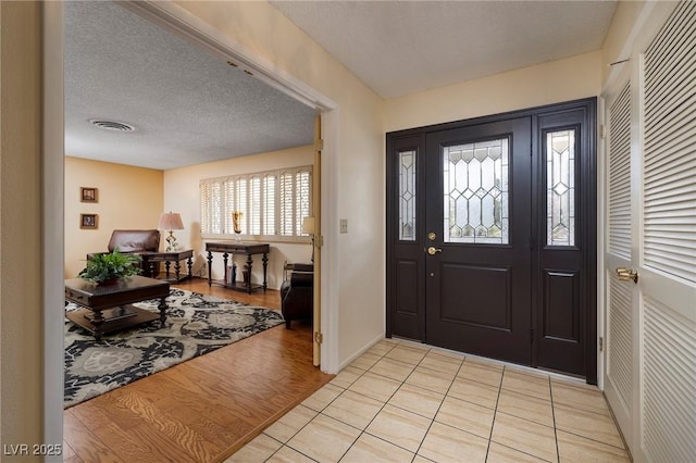 4219 E Pinecrest Cir, Las Vegas, NV 89121 - foyer with a textured ceiling, light tile patterned flooring, and baseboards