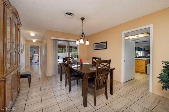 4219 E Pinecrest Cir, Las Vegas, NV 89121 - dining room with light tile patterned floors, a chandelier, and a textured ceiling