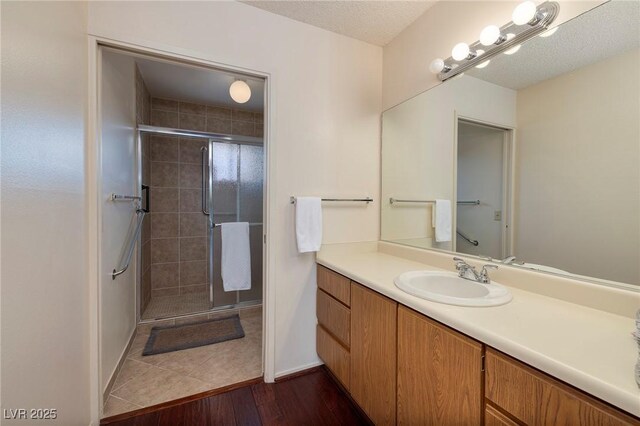 4219 E Pinecrest Cir, Las Vegas, NV 89121 - bathroom featuring vanity, a stall shower, and wood finished floors