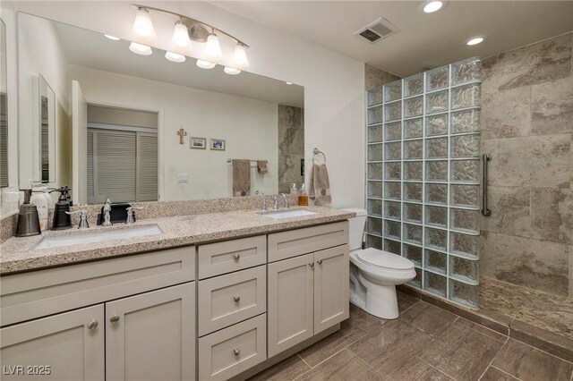 4219 E Pinecrest Cir, Las Vegas, NV 89121 - bathroom with a walk in shower, double vanity, toilet, and recessed lighting