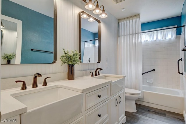7417 Radville Dr, Las Vegas, NV 89129 - bathroom featuring toilet, double vanity, wood finished floors, and shower / tub combo with curtain