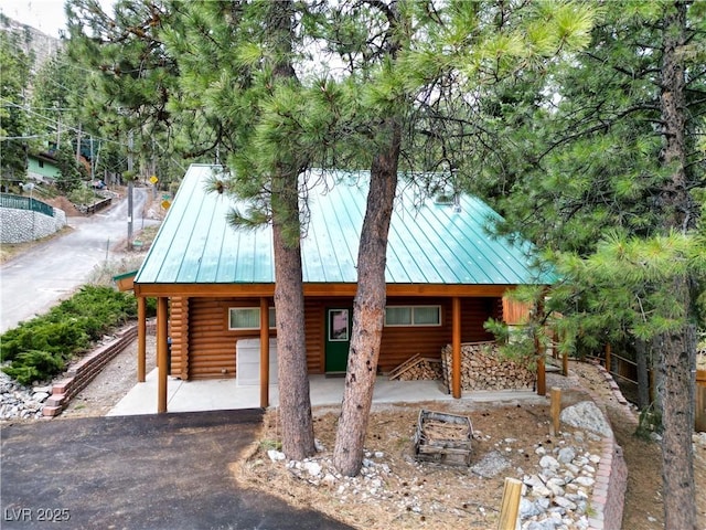 401 Alpine Way, Las Vegas, NV 89124 - view of front of property with a standing seam roof, log siding, and metal roof