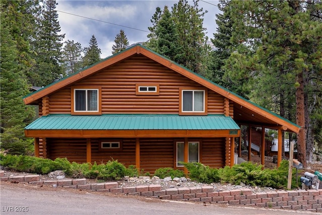 401 Alpine Way, Las Vegas, NV 89124 - view of front of property with log siding and metal roof