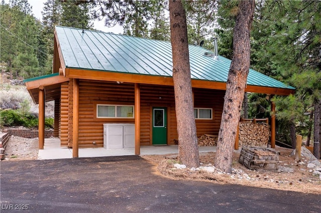 401 Alpine Way, Las Vegas, NV 89124 - view of front of house featuring a standing seam roof, metal roof, and log veneer siding