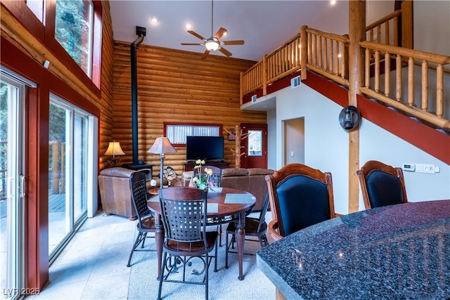 401 Alpine Way, Las Vegas, NV 89124 - dining area featuring rustic walls, a high ceiling, a ceiling fan, a wood stove, and recessed lighting