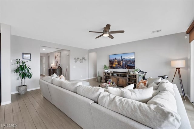 7115 Calvert Cliffs St, North Las Vegas, NV 89084 - living room featuring a ceiling fan, baseboards, and light wood finished floors