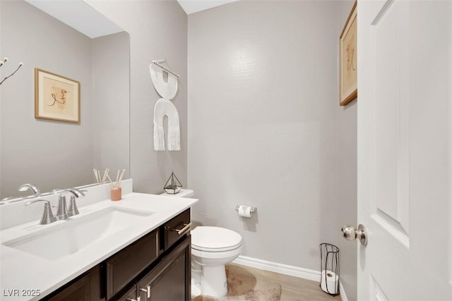 7115 Calvert Cliffs St, North Las Vegas, NV 89084 - bathroom featuring toilet, vanity, and baseboards