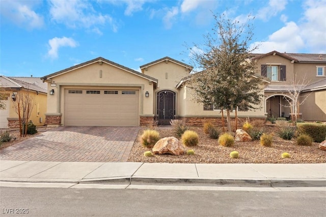 7115 Calvert Cliffs St, North Las Vegas, NV 89084 - view of front of house featuring stucco siding, decorative driveway, and a garage