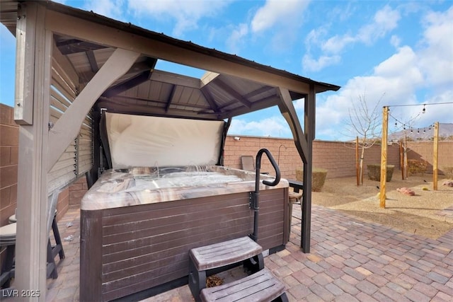 7115 Calvert Cliffs St, North Las Vegas, NV 89084 - fenced backyard with a hot tub, a gazebo, and a patio area