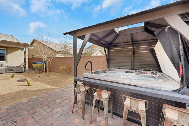 7115 Calvert Cliffs St, North Las Vegas, NV 89084 - fenced backyard with an outdoor hangout area, a patio area, and a hot tub