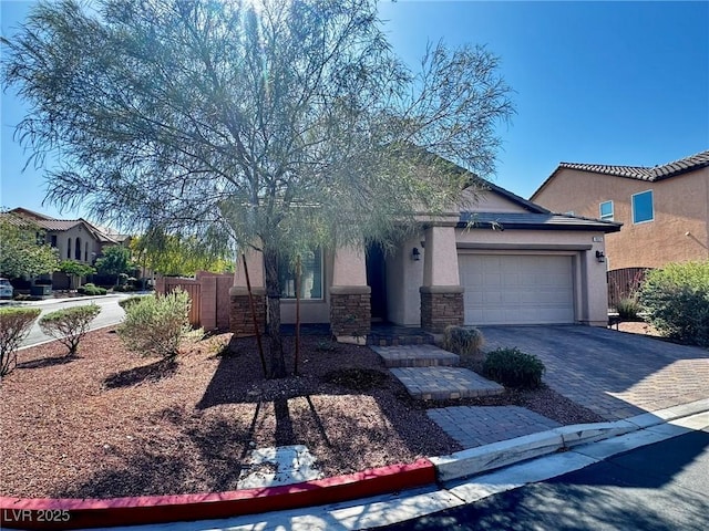 7035 Thistle Ridge St, Las Vegas, NV 89166 - obstructed view of property featuring stucco siding, a garage, decorative driveway, and stone siding