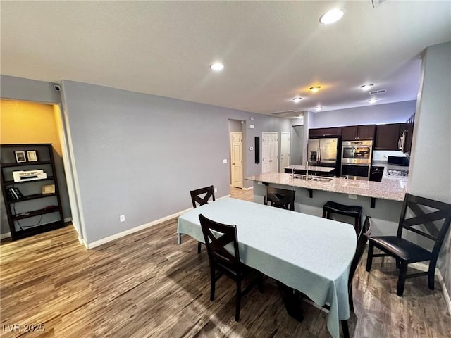 7035 Thistle Ridge St, Las Vegas, NV 89166 - dining room with baseboards, wood finished floors, and recessed lighting