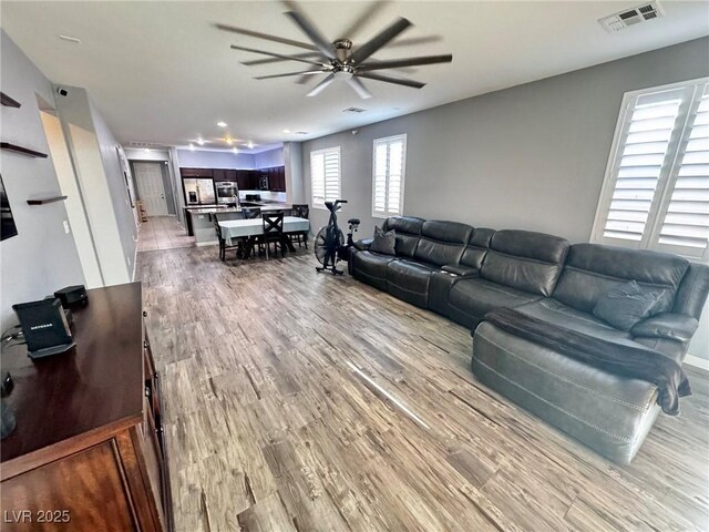7035 Thistle Ridge St, Las Vegas, NV 89166 - living room with light wood-type flooring and ceiling fan