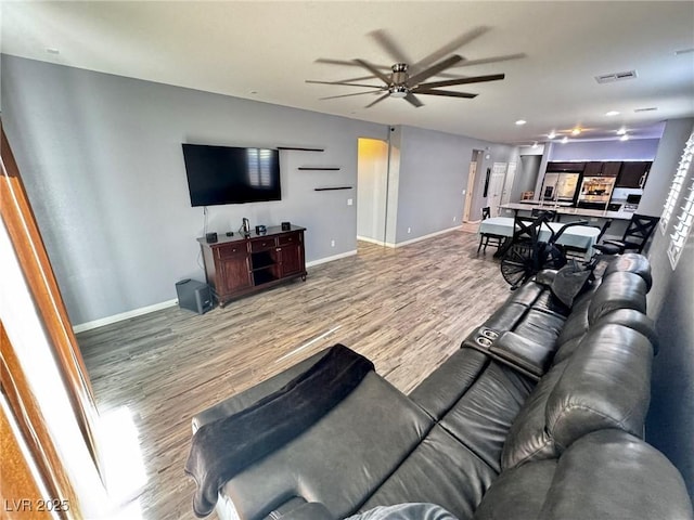 7035 Thistle Ridge St, Las Vegas, NV 89166 - living room featuring a ceiling fan, wood finished floors, and baseboards