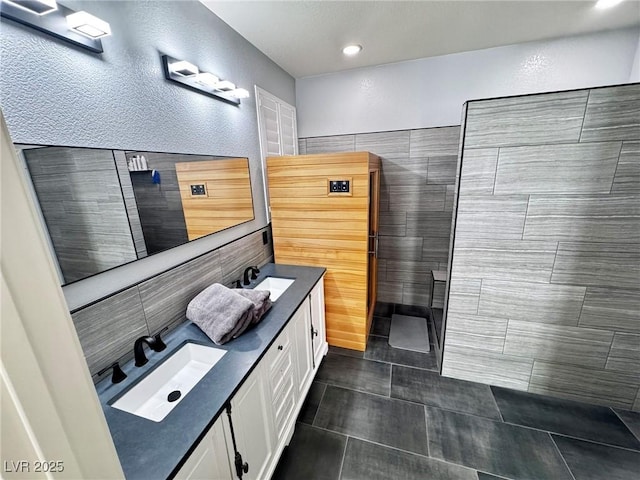 7035 Thistle Ridge St, Las Vegas, NV 89166 - full bath featuring double vanity, tile walls, recessed lighting, and tile patterned floors