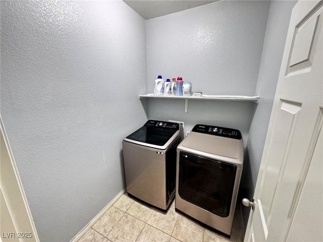 7035 Thistle Ridge St, Las Vegas, NV 89166 - laundry area featuring independent washer and dryer, light tile patterned flooring, baseboards, and a textured wall