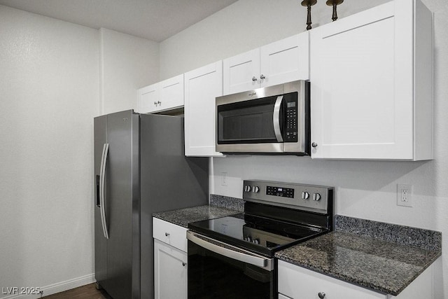 532 Clearsable Ave, Henderson, NV 89044 - kitchen with appliances with stainless steel finishes, white cabinetry, dark stone counters, baseboards, and dark wood finished floors