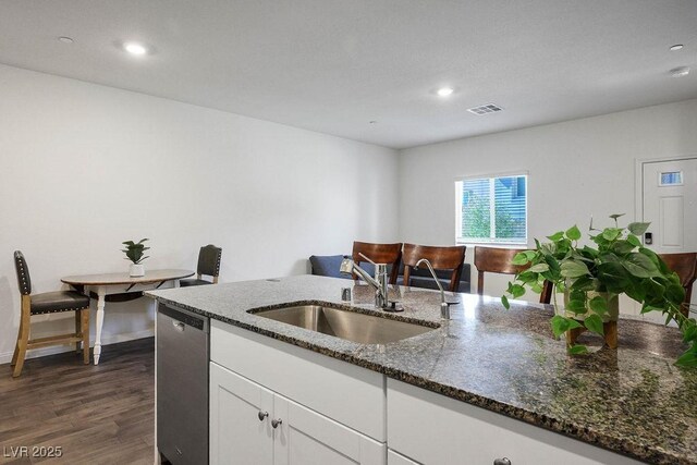 532 Clearsable Ave, Henderson, NV 89044 - kitchen with a sink, dishwasher, dark wood-type flooring, white cabinets, and dark stone counters