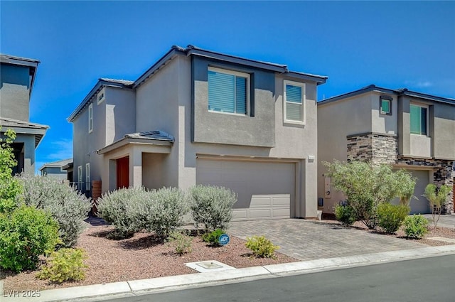 4160 Elegant Chateau St, Las Vegas, NV 89135 - view of front of home with a garage, stucco siding, driveway, and stone siding