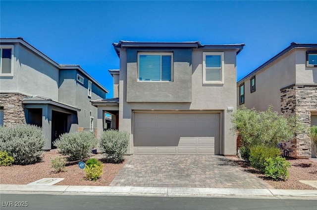 4160 Elegant Chateau St, Las Vegas, NV 89135 - view of front of property featuring an attached garage, stucco siding, and decorative driveway