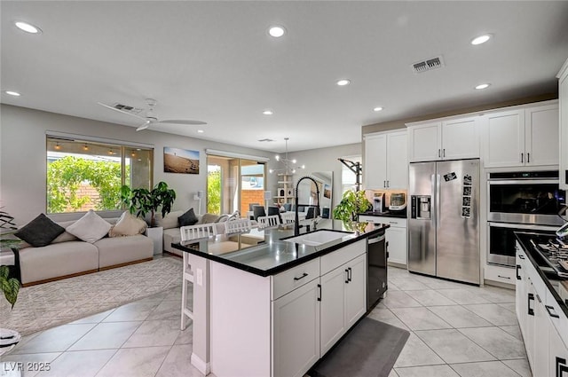 4160 Elegant Chateau St, Las Vegas, NV 89135 - kitchen with stainless steel appliances, a sink, dark countertops, open floor plan, and recessed lighting