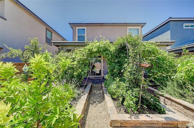 4160 Elegant Chateau St, Las Vegas, NV 89135 - view of front of property featuring stucco siding and a garden