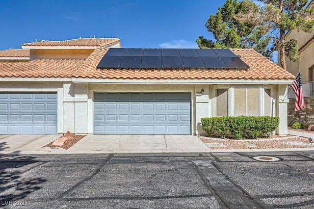 310 Pissarro Pl, Henderson, NV 89074 - view of front of property featuring concrete driveway, solar panels, stucco siding, and a garage
