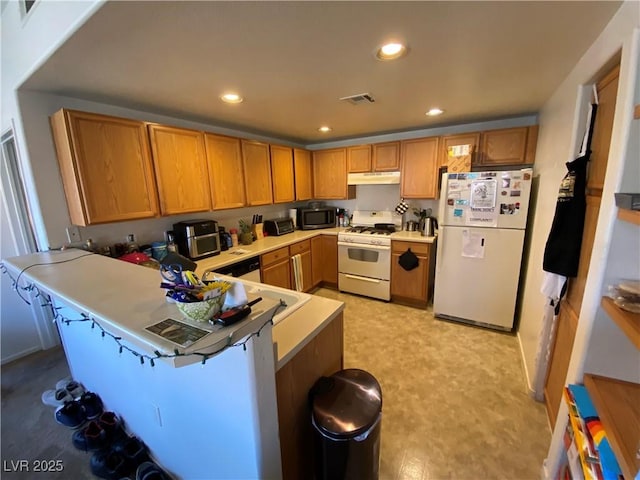 9580 W Reno Ave Unit 283, Las Vegas, NV 89148 - kitchen featuring white appliances, under cabinet range hood, a peninsula, recessed lighting, and light flooring
