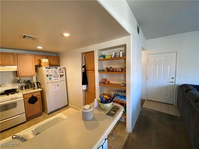 9580 W Reno Ave Unit 283, Las Vegas, NV 89148 - kitchen featuring white appliances, under cabinet range hood, light countertops, a sink, and recessed lighting