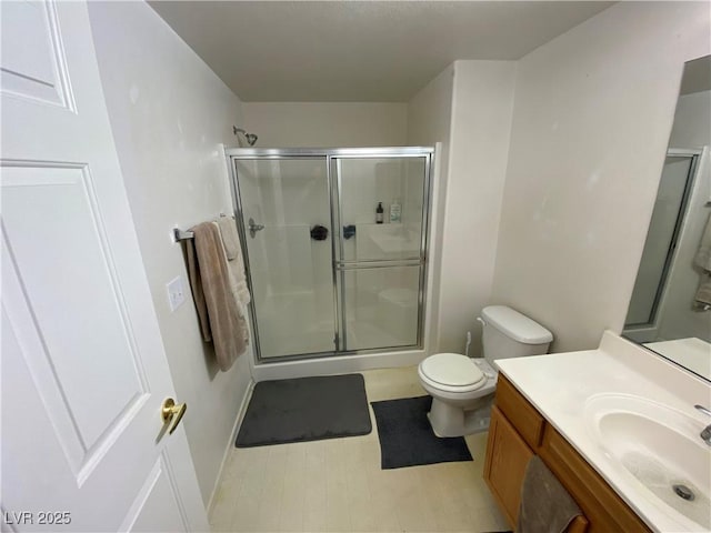9580 W Reno Ave Unit 283, Las Vegas, NV 89148 - bathroom featuring a stall shower, vanity, toilet, baseboards, and tile patterned floors