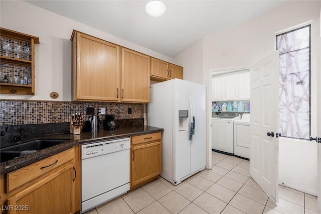 3121 Fontana Colony Ct, North Las Vegas, NV 89031 - kitchen featuring white appliances, independent washer and dryer, decorative backsplash, light tile patterned floors, and dark stone countertops
