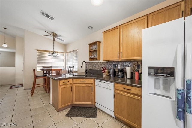 3121 Fontana Colony Ct, North Las Vegas, NV 89031 - kitchen with white appliances, a sink, ceiling fan, dark countertops, and a peninsula