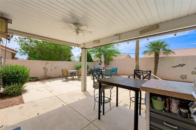 3121 Fontana Colony Ct, North Las Vegas, NV 89031 - fenced backyard with outdoor dining area, a patio area, and a ceiling fan