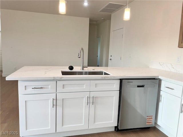 1905 Harvard St, North Las Vegas, NV 89030 - kitchen with dishwasher, a sink, white cabinetry, light stone countertops, and decorative light fixtures