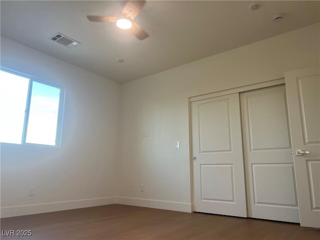 1905 Harvard St, North Las Vegas, NV 89030 - unfurnished bedroom featuring wood finished floors, baseboards, a closet, and a ceiling fan