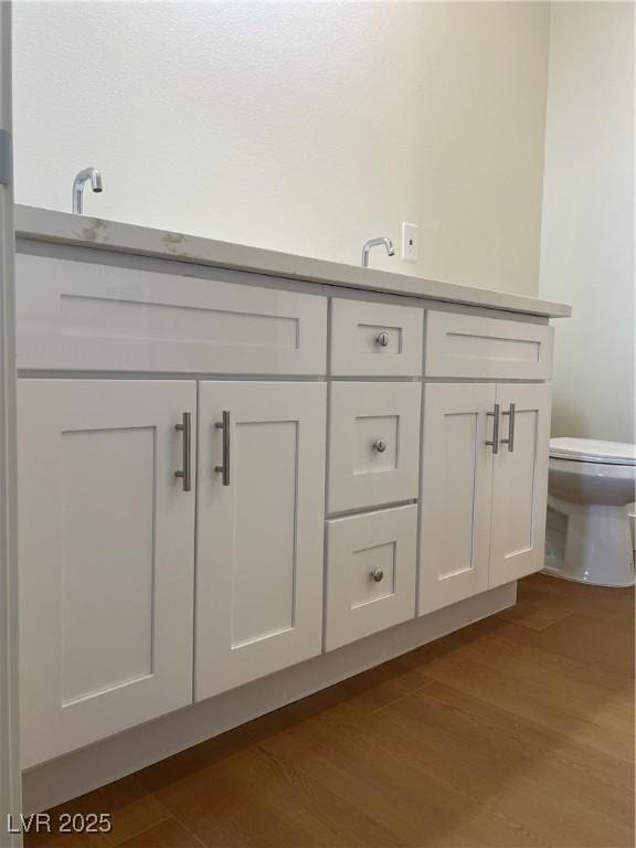 1905 Harvard St, North Las Vegas, NV 89030 - bathroom with toilet, wood finished floors, and vanity