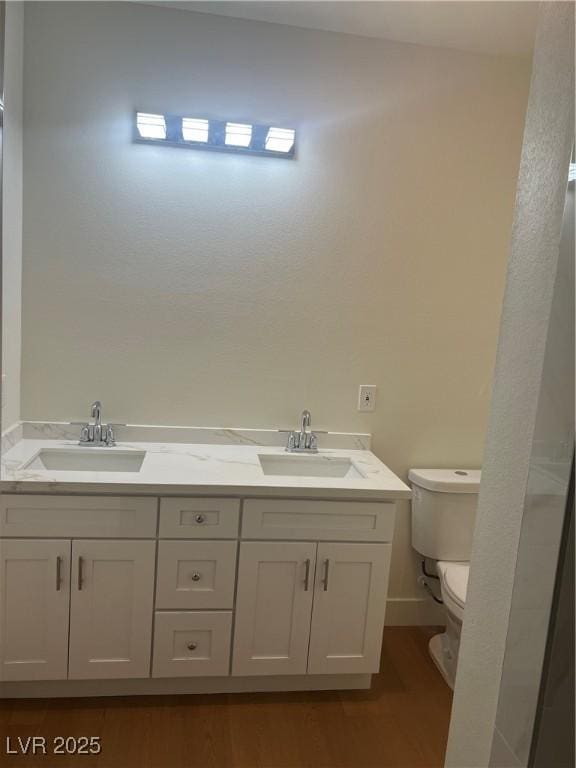 1905 Harvard St, North Las Vegas, NV 89030 - full bathroom featuring toilet, double vanity, and wood finished floors
