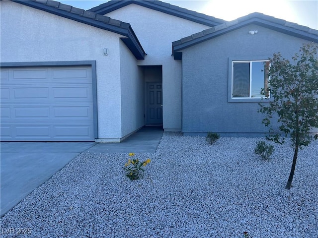 1905 Harvard St, North Las Vegas, NV 89030 - view of front of property with stucco siding and an attached garage