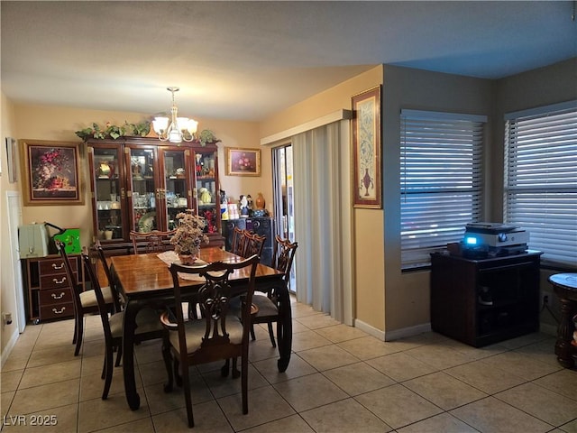 4612 Supreme Ct, Las Vegas, NV 89110 - dining space with a chandelier, light tile patterned floors, and baseboards