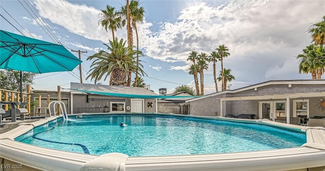 5217 Champions Ave, Las Vegas, NV 89142 - view of pool with french doors and an outbuilding