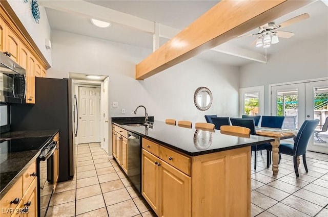 5217 Champions Ave, Las Vegas, NV 89142 - kitchen featuring dishwasher, light tile patterned floors, a sink, a peninsula, and black range with electric cooktop