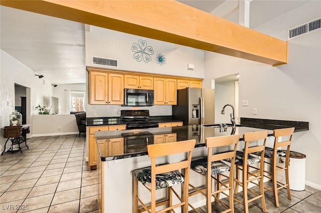 5217 Champions Ave, Las Vegas, NV 89142 - kitchen featuring black / electric stove, stainless steel refrigerator with ice dispenser, a sink, a peninsula, and dark countertops