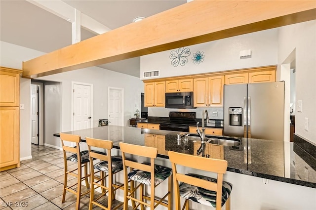 5217 Champions Ave, Las Vegas, NV 89142 - kitchen with appliances with stainless steel finishes, a sink, a towering ceiling, a kitchen breakfast bar, and light brown cabinets