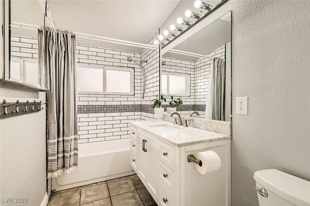 5217 Champions Ave, Las Vegas, NV 89142 - bathroom with toilet, shower / bath combo, vanity, tile patterned floors, and a textured wall