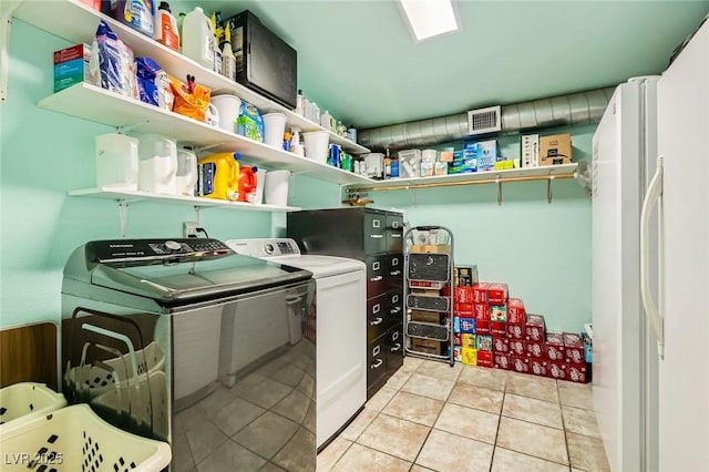 5217 Champions Ave, Las Vegas, NV 89142 - laundry area featuring washer and dryer and light tile patterned floors